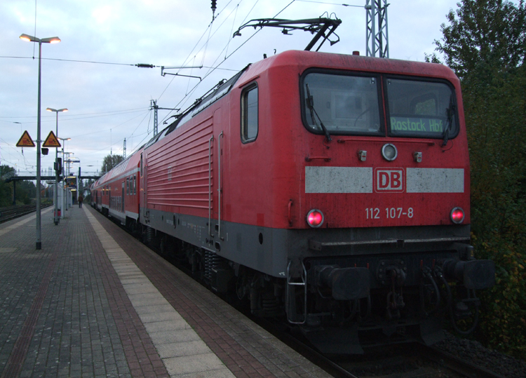 112 107-8 mit S1 von Warnemnde Richtung Rostock Hbf kurz nach der Ankunft im Bahnhof Rostock-Bramow.(12.10.10)