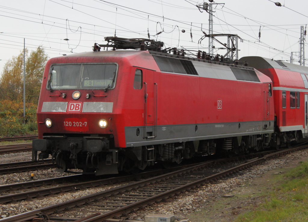 Die schmutzige 120 202-7 mit RE 4308 von Rostock Hbf nach Hamburg Hbf bei der Ausfahrt im Rostocker Hbf.24.10.2015
