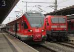 429 529-1 steht als RE9 Rostock-Sassnitz abfahrbereit auf Gleis 3 neben wurde 143 841-5 mit S1 nach Warnemnde bereitgestellt.08.02.2013