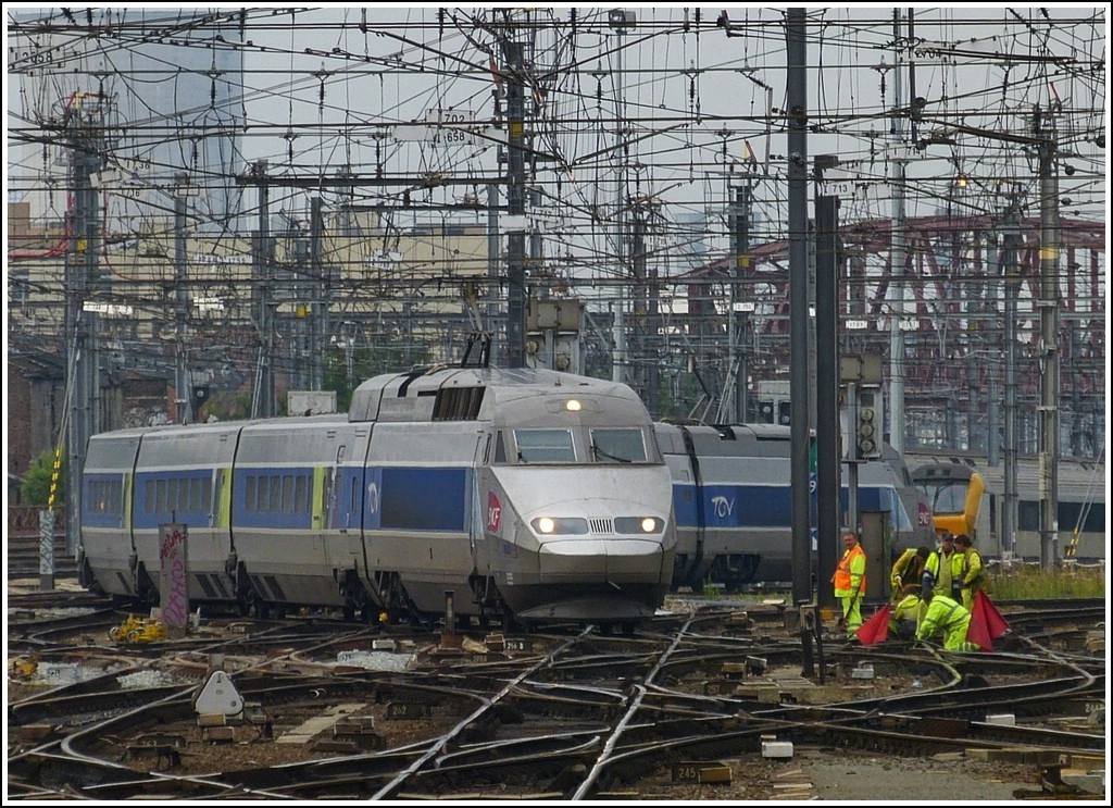 Unter einem regelrechten Drahtverhau und den aufmerksamen Blicken eines Bautrupps windet sich der TGV Rseau 4520 ber die Weichen bei der Einfahrt in den Bahnhof Bruxelles Midi. 25.06.2012 (Hans)