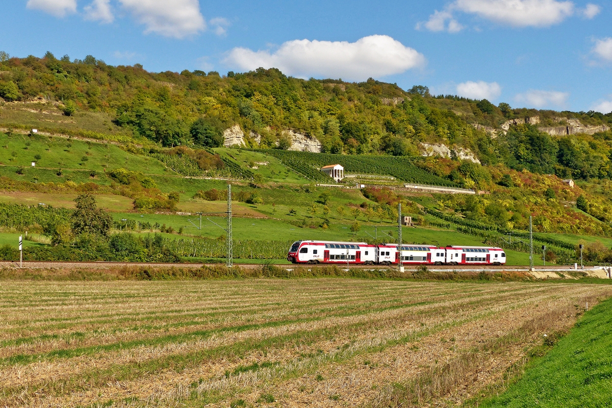 . Ein CFL KISS in wunderschner Umgebung - Zwischen Wasserbillig und Igel fhrt die Bahnstrecke mitten durch die Weinberge in der Nhe von Liersberg an dem interessanten Grutenhuschen vorbei. Ein unbekannt gebliebener CFL KISS kommt am 27.09.2015 aus Trier und wird bald den Bahnhof von Wasserbillig erreichen. (Jeanny)

Das Grutenhuschen ist ein teilrekonstruierter rmischer Grabtempel, der sich in einem Weinberghang nahe der Gemeinde Igel an der Mosel befindet. Es wurde auf den Resten der ursprnglichen Grabkammer 1962 vom Rheinischen Landesmuseum Trier restauriert. 2001 wurden die oberen und vorderen Teile des ursprnglichen Tempels rekonstruiert. Der zweigeschossige Grabtempel wurde im 3./4. Jahrhundert errichtet, nachdem Augusta Treverorum (Trier) Kaiserresidenz geworden war. Unterhalb des Grutenhuschens (Grut = Grotte) verlief entlang der Mosel die rmische Strae nach Trier. In der Nhe wurden die Reste eines rmischen Gebudes entdeckt, die auf die Wohnsttte der Erbauer deuten. Das Untergeschoss besteht aus einem berwlbtem Raum, in dem die steinernen Srge der Verstorbenen aufbewahrt wurden. Nachdem bisher die Verbrennung der Toten mit anschlieender Urnenbestattung blich gewesen war, kam bei Christen und Nicht-Christen ab der zweiten Hlfte des 3. Jahrhunderts die Krperbestattung in Mode. Ein Beispiel fr die bisher durchgefhrten Urnenbestattungen ist die Igeler Sule, die sich unweit des Grutenhuschens in Igel befindet. ber der Grabkammer befindet sich ein fast quadratischer Raum, der als Versammlungssttte fr Totengedenken genutzt wurde. Vom rmischen Dichter Ausonius ist berliefert, dass der Lauf der Mosel mit prchtigen Villenanlagen gesumt war, die zweifellos mit weiteren Begrbnissttten ausgestattet waren. Heute wird das Grutenhuschen fr Feste und standesamtliche Trauungen genutzt. (Quelle: Wikipedia)