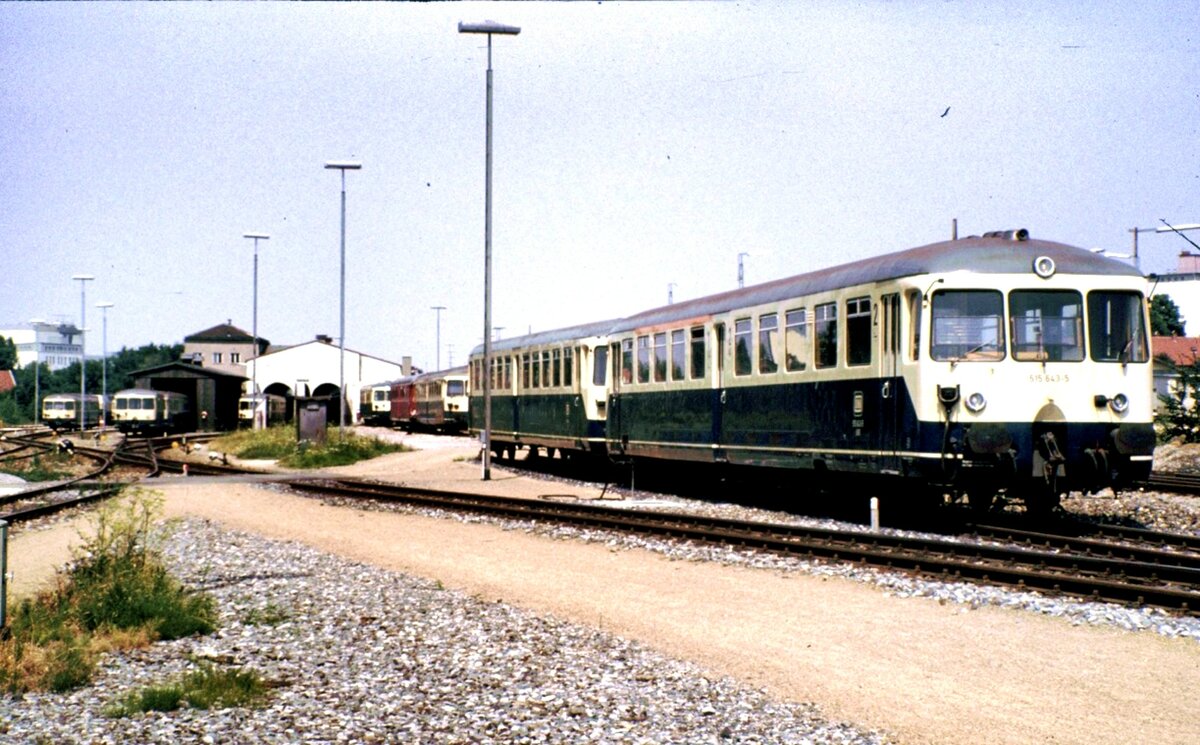 515 643-5 mit Beiwagen 815 und weitere Fahrzeuge in Buchloe am 24.07.1983.