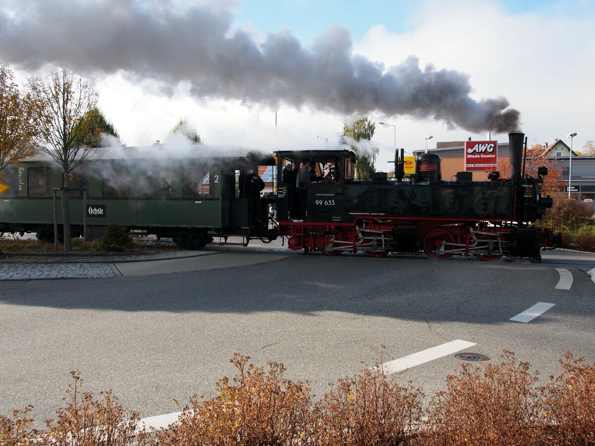 99 633 das Öchsle fährt nach der Bahnhofsausfahrt über einen ampelgesteuerten Kreisverkehr in Ochsenhausen am 24.10.2021.
