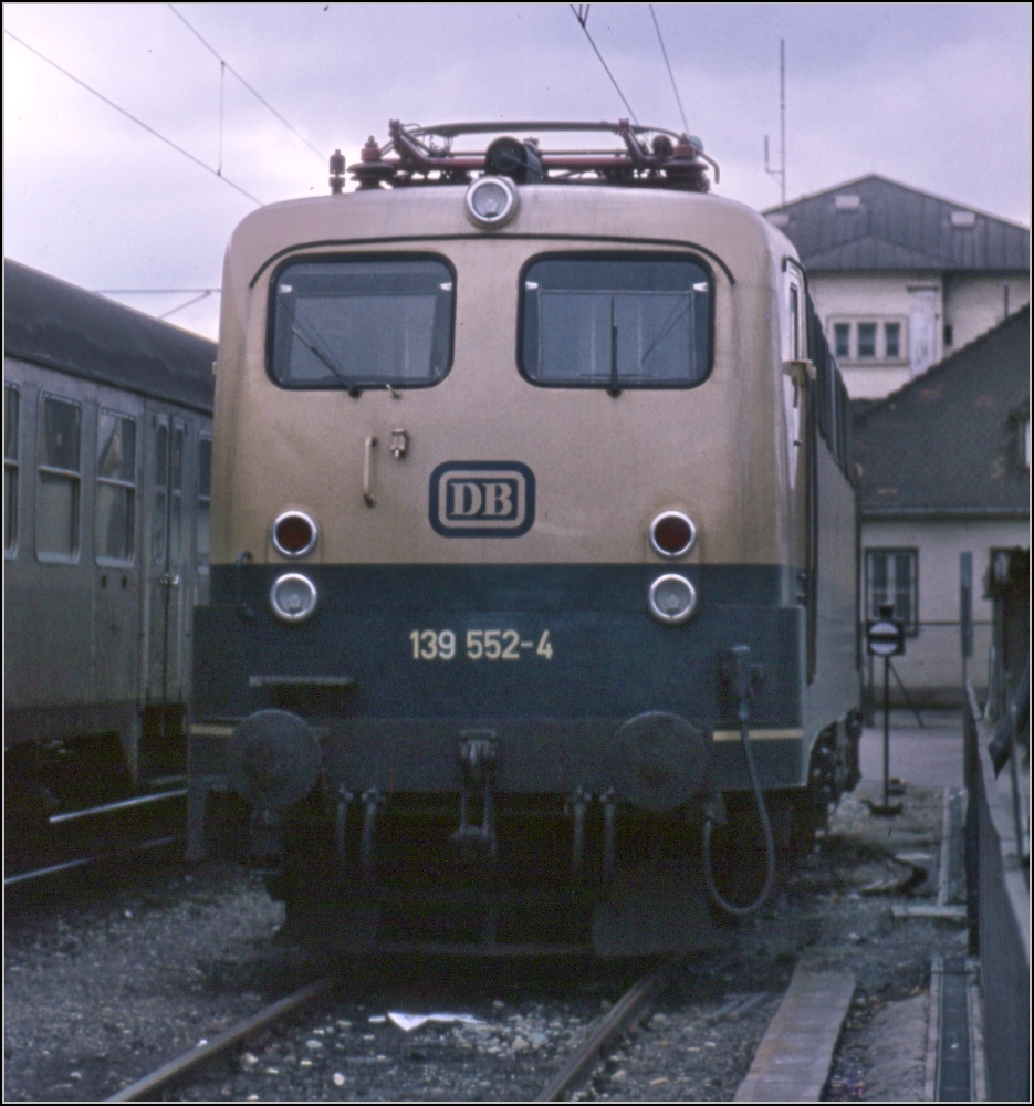 Sonntagsruhe in Singen.

139 552-4 parkt neben Gleis 8 am Singener Bahnhof. Damals die neue, ungeliebte Lackierung in ozeanblau-beige. Die Baureihe 139 war meist über die Schwarzwaldbahn unterwegs, über die Gäubahn kam die 140 nach Singen. Von dort wurde bis Schaffhausen Diesel vorgespannt, Fahrdraht war noch nicht verfügbar im März 1979.
