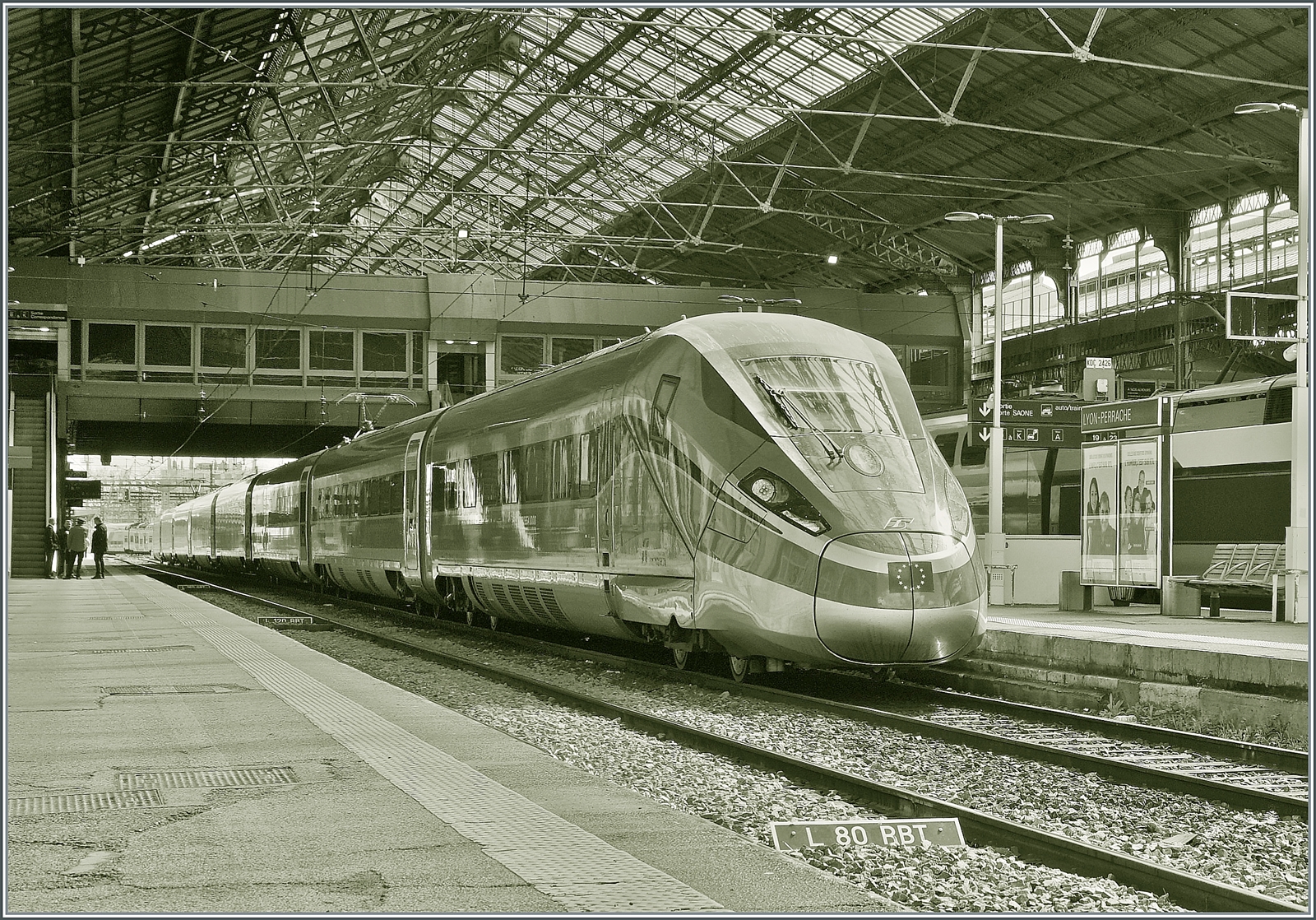 Der FS Trenitalia ETR 400 031 ist als Frecciarossa FR 6647 um 11:48 in Lyon Perrache unter der mächtigen Halle angekommen und bleibt bis zur Rückfahrt um 13:11 als FR 6654 nach Paris gleich hier stehen.
Hier die Ansicht vom anderen Bahnsteig aus, leider mit Gegenlicht - und aus diesem Grund auch als S/W Version, dafür aber kommen die charakteristischen Formen des ETR 400 031 sehr schon zur Geltung.

13. März 2024