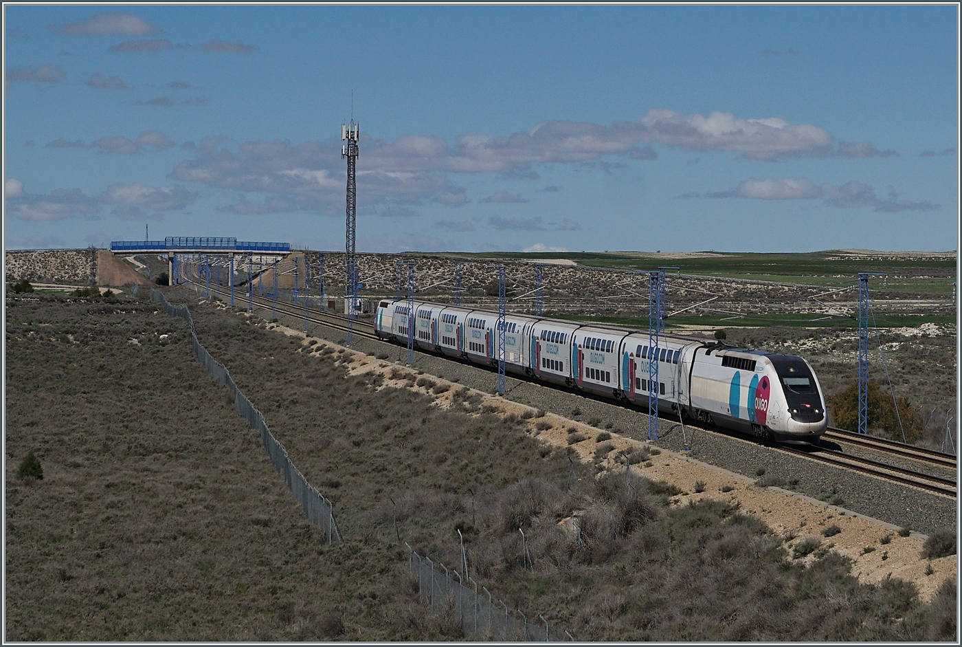 Es tummeln sich allerlei Gesellschaften im Hochgeschwindigkeitsverkehr zwischen Madrid und Barcelona, neben RENFE und IRYO so auch die SNCF mit ihrem OUIGO Espagne; der TGV Rame 813 ist als OUIGO Espagne 6501 bei Bujaraloz von Madrid (10:05) nach Barcelona Sants (an 13:00) unterwegs. Der Zug hält unterwegs in Zaragoza Delicias und Camp de Tarragona. Das Bild zeigt die Schnellfahrstrecke bei Streckenkilometer 370.5 (ab Madrid) im flachen Land, wie man sich so gemeinhin Spanien vorstellt, doch interessanterweise erreicht die Strecke in den Sierre Ministra bei Streckenkilometer 152,7 eine Höhe von 1217 müM und ist damit die höchst gelegene Schnellfahrstrecken Europas! 

18. April 2024 