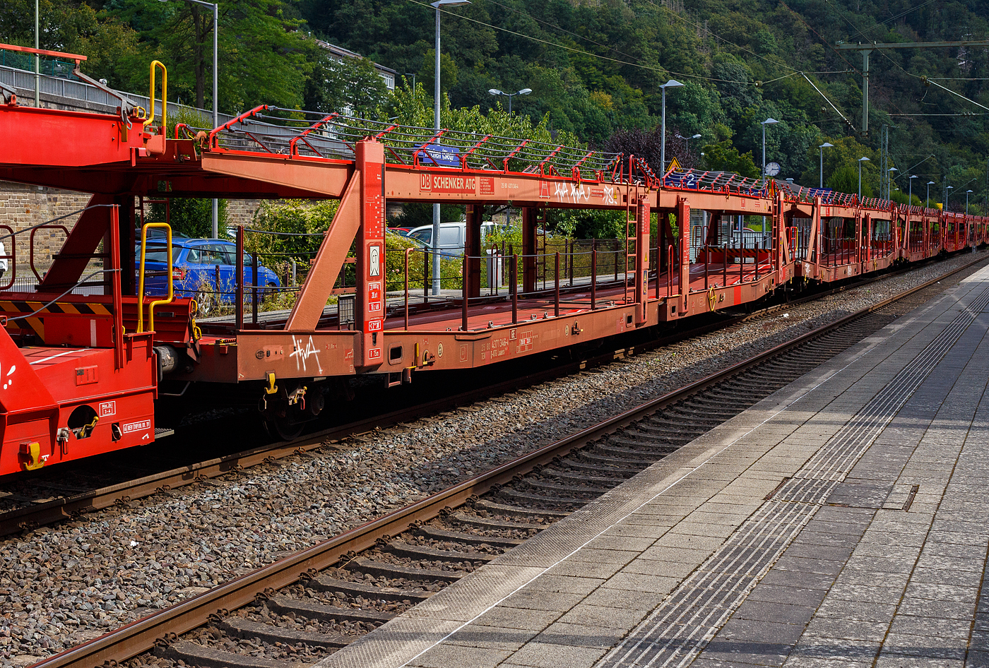 Leerer vierachsiger (2 x zweiachsiger) Doppelstock-Autotransportwagen 25 80 4371 346 D-ATG der Gattung Laaers 560.1 (BA 5.854) der DB Cargo Logistics GmbH (ex DB Schenker ATG) am 20 August 2024 im Zugverband bei der Durchfahrt in Kirchen (Sieg).

Der Wagen wurde 2011 von der damaligen DB Waggonbau Niesky GmbH gebaut.

Diese Waggons haben zwei Ladeebenen und sind für den europaweiten Transport geeignet. Sie werden für den internationalen Transport von PKWs, SUVs und Vans eingesetzt und bieten maximale Flexibilität durch eine stufenlos verstellbare obere Ladeebene. Aufgrund der hohen Lastgrenze (bis 34 t) ist der Transport von besonders schweren Fahrzeugen der genannten Typen möglich.

Damit sowohl ein typenreiner Transport als auch eine Mischverladung in den unterschiedlichen Lademaßen möglich ist, kann die obere Ladeebene hinsichtlich der Transportstellungen stufenlos eingestellt werden.

Durch die Entwicklung eines veränderten Ladungssicherungssystems wurde den Kundenanforderungen nach optimierten Transportmöglichkeiten für Fahrzeuge mit niedrigerer Bodenfreiheit Rechnung getragen.

TECHNISCHE DATEN:
Gattung: Laaers (Bauart 560.1)
Erstes Baujahr der Wagengattung: 2007
Spurweite: 1.435 mm
Anzahl der Achsen: 4 (2 x 2)
Länge über Puffer : 31.000 mm
Achsabstände: 10.000 mm / 5.160 mm / 10.000 mm
Laufraddurchmesser (neu): äußere 840 mm und mittlere 730 mm
Ladelänge : 30.070 mm (unten) / 30.550 mm (oben)
Ladelänge waagerechter Teil untere Ebene: 19.400 mm
Ladebreite : 2.950 (unten) / 2.750 mm (oben)
Höchstgeschwindigkeit: 100 km/h (120 km/h leer)
Eigengewicht: 31.000 kg
Max. Zuladung bei Lastgrenze S: 33,0 t (ab Streckenklasse B, bei A 29,0 t)
Max. Zuladung der Ladeebenen: unten und oben jeweils max. 18 t
Max. Gewicht je Pkw: 2.800 kg (Radlast max. 1 t)
Anzahl der Radvorleger: 64
Höhe Geländer oben: 600 mm
Kleinster befahrb. Gleisbogenhalbmesser: 75 m
Bremse: KE-GP-A (K)
Bremssohle: Jurid 816 M
Handbremse: Ja
Intern. Verwendungsfähigkeit: TEN-GE

Der große Unterschied zwischen den Laaers-Wagen der Bauart 560.1  (wie hier) und der Bauart 560.2 sind das Lastgrenzenraster (Max. Zuladung), die Bauart 560.1 ist meist 500 kg schwerer als die Bauart 560.2.

