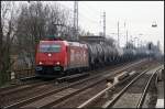 HGK 185 589-9 mit einem Kesselzug Richtung Norden (gesehen Berlin Karow 16.02.2011)